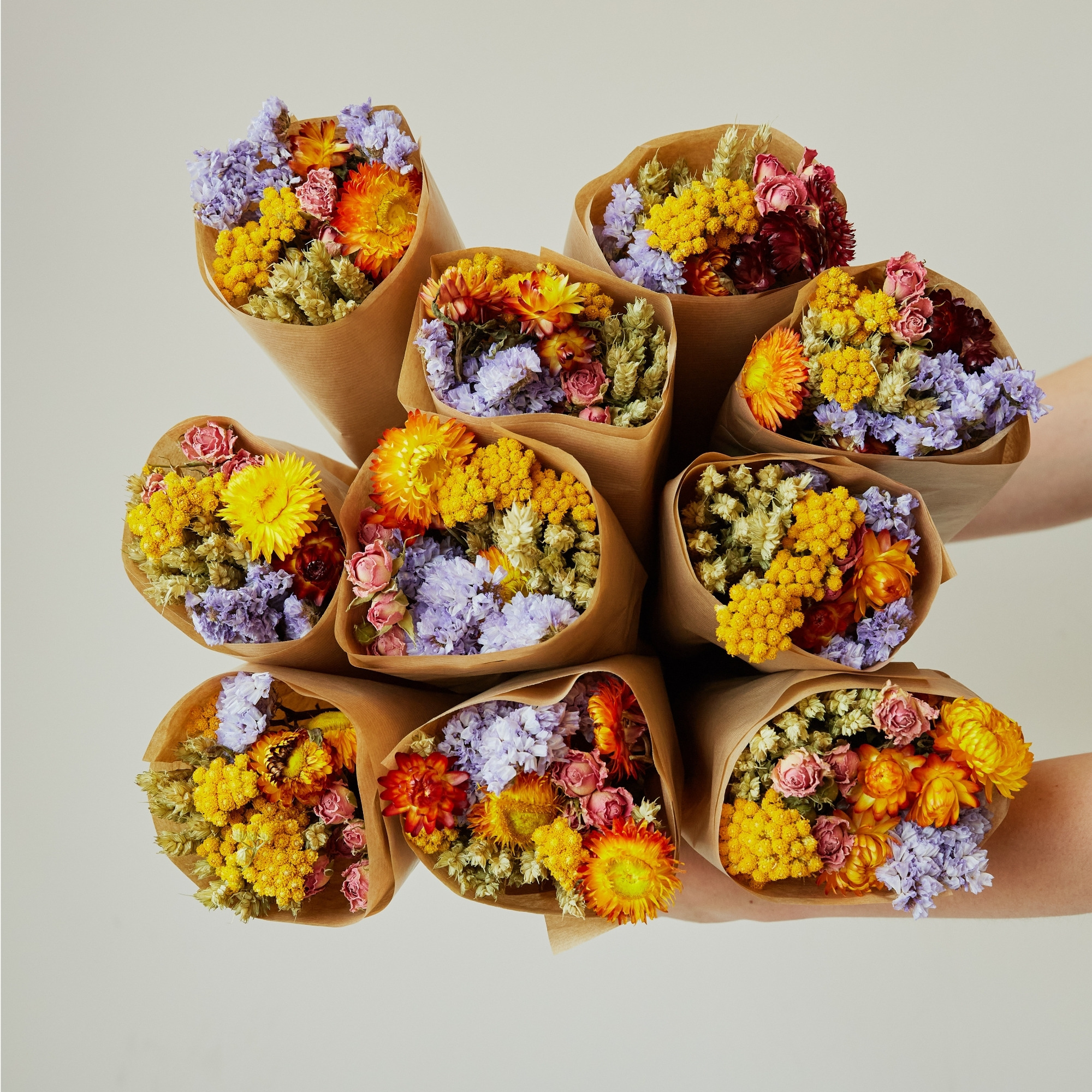 Colorful dried market bouquets wrapped in kraft paper